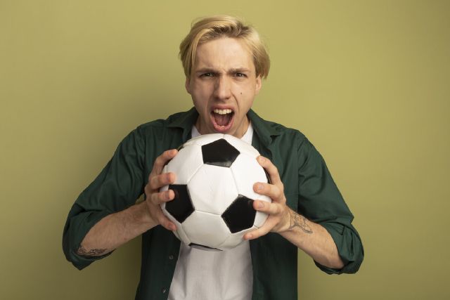images/angry-young-blonde-guy-wearing-green-t-shirt-holding-ball.jpg