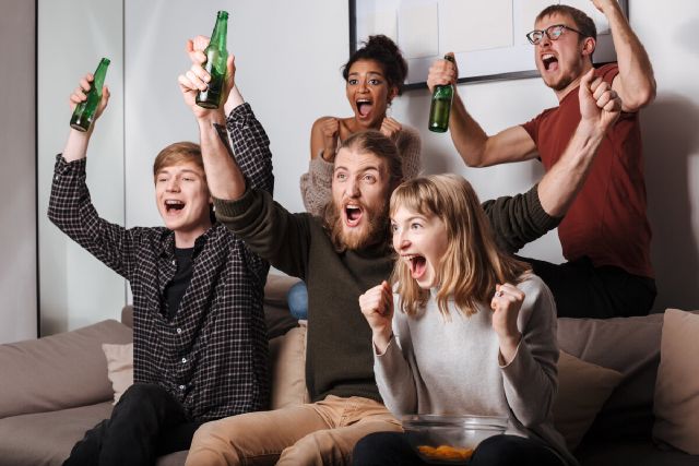 images/group-joyful-friends-sitting-sofa-happily-screaming-while-watching-tv-together-with-chips-beer-home.jpg